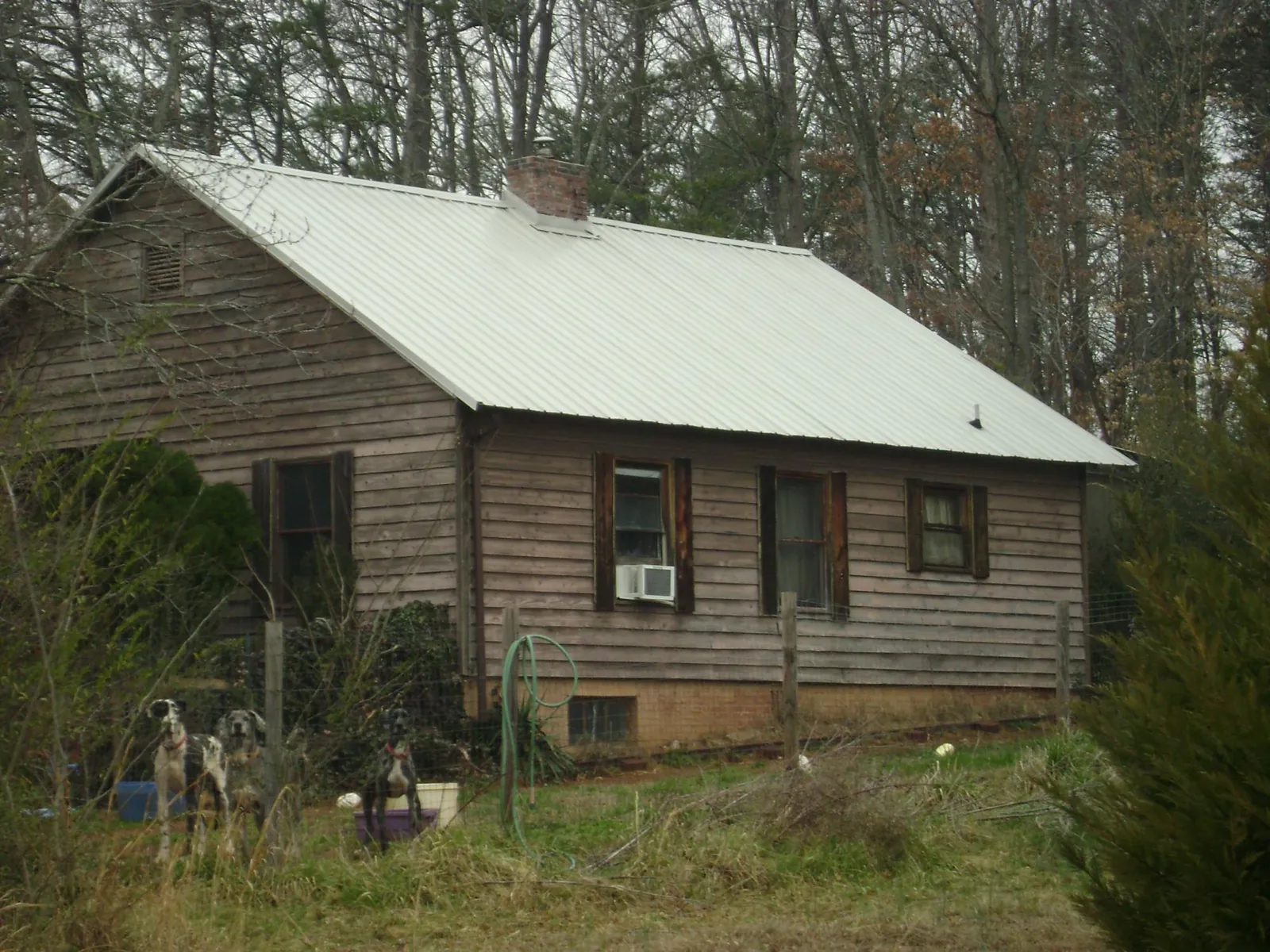 White metal roof on an old wood sided farmhouse, from a Metal Roof Installation job in Mill Hall